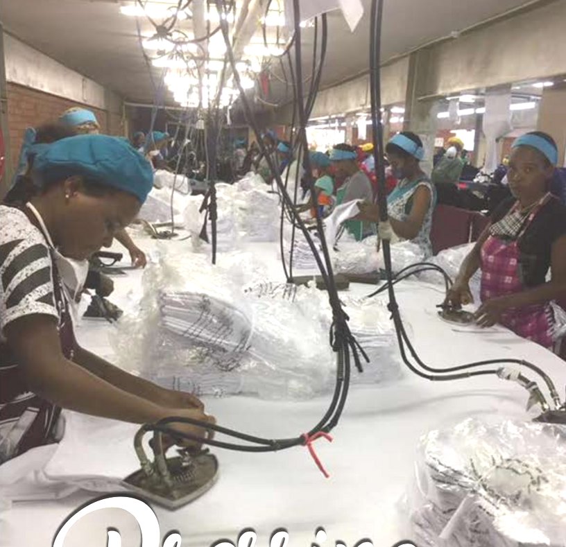 Worker pressing a finished knitted garment with a steam iron